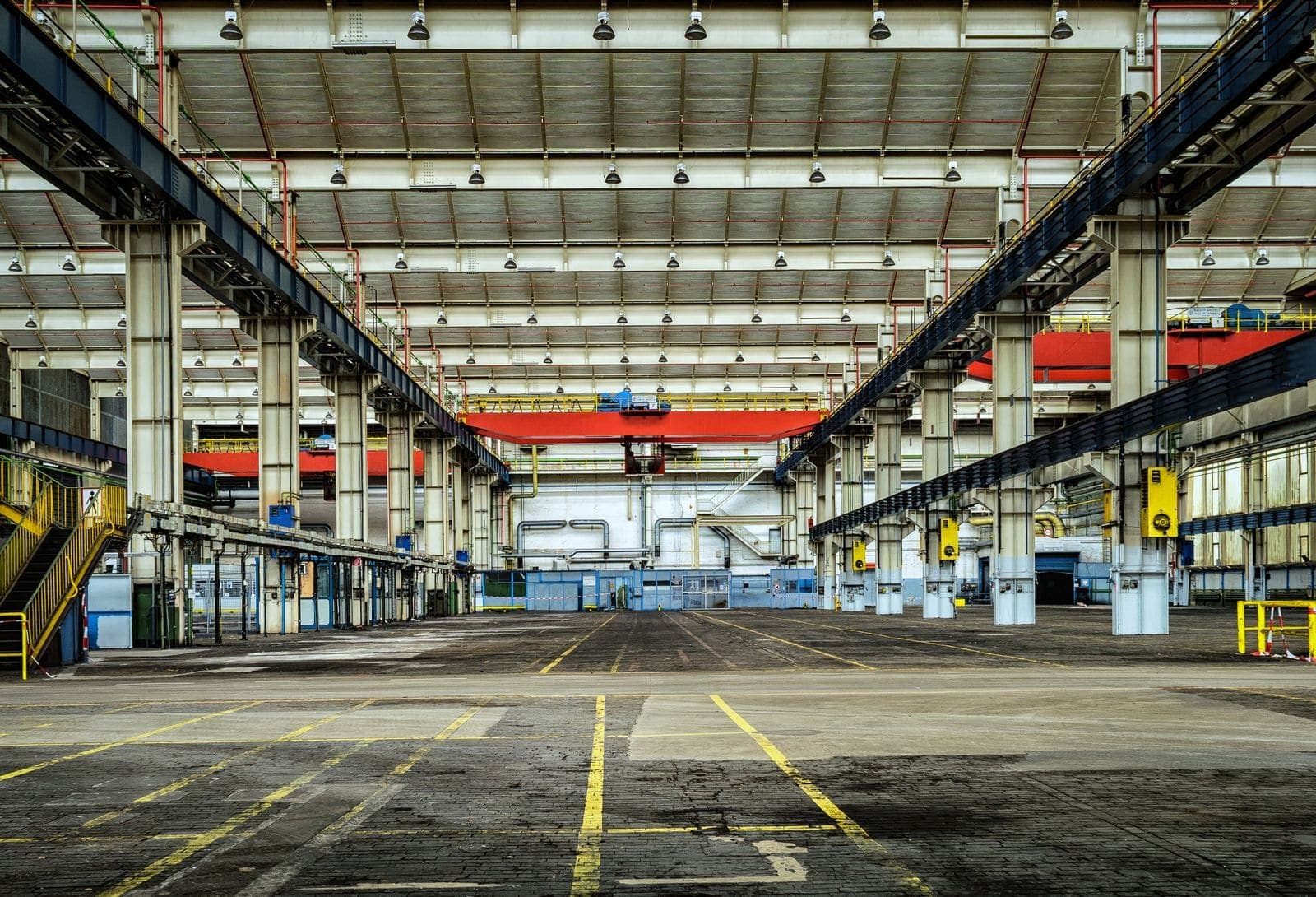 Large manufacturing plant floor with clear concrete and overhead crane