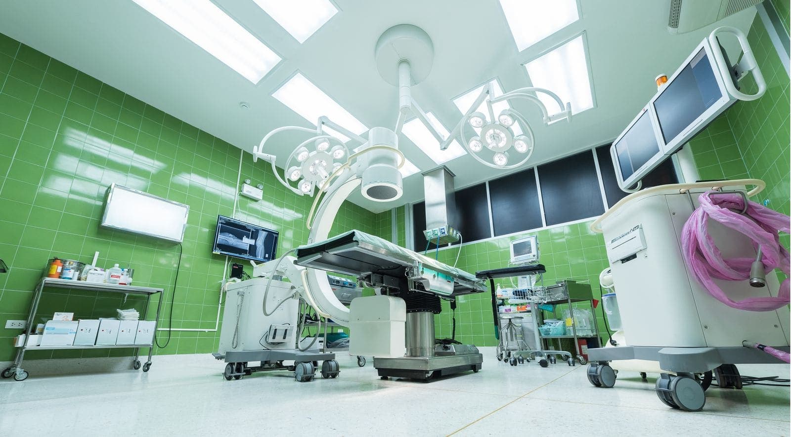 Clean hospital operating room with polished floors and clinical equipment