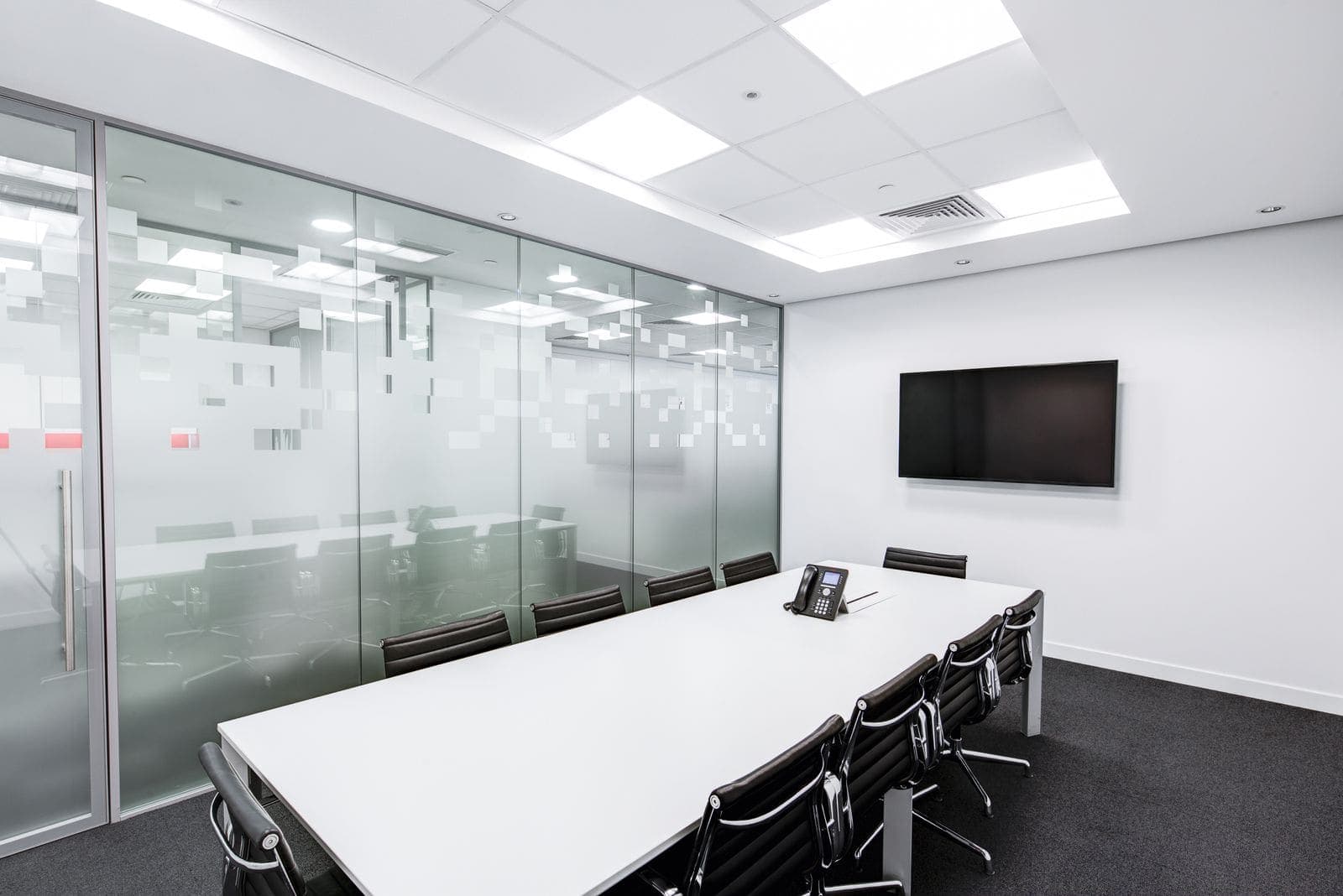 Spotless corporate conference room with glass partitions after commercial cleaning