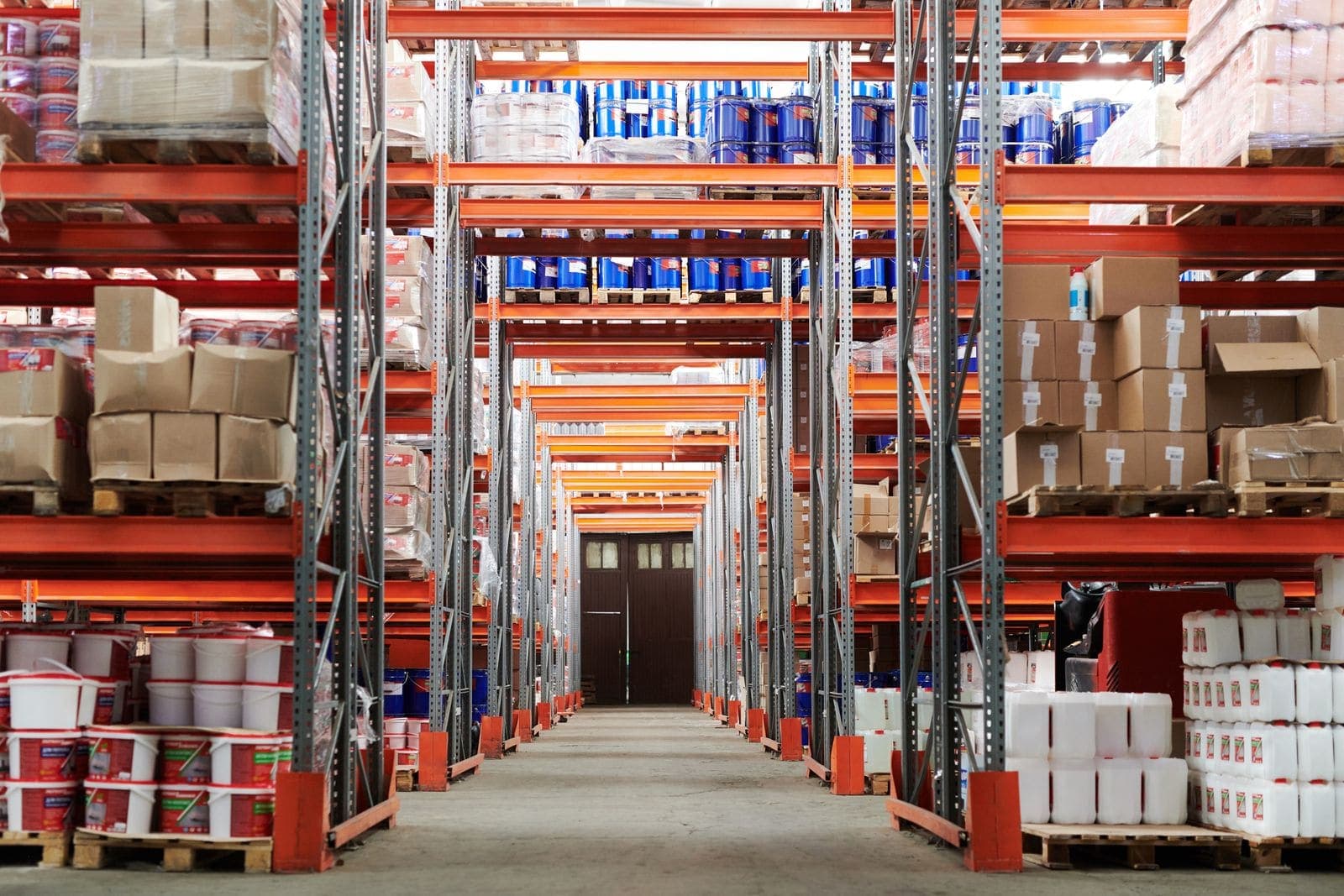 Organized warehouse aisle with clean concrete floors and pallet racking